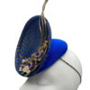 Blue and gold chevron detail percher with gold flower and quill detail.